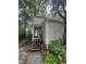 View of the home's front door with wooden steps and an inviting, landscaped entrance surrounded by lush greenery at 130 Beechwood Dr, Carrboro, NC 27510