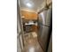 Galley kitchen featuring stainless steel appliances, wooden cabinets, and complementary countertops at 130 Beechwood Dr, Carrboro, NC 27510