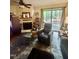 Cozy living room features a fireplace, plush seating, and a sliding glass door to the deck at 130 Beechwood Dr, Carrboro, NC 27510