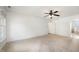 Large carpeted bedroom featuring ceiling fan and view into ensuite bath at 1401 Brewer Jackson Ct, Wake Forest, NC 27587