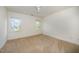 Carpeted bedroom with two bright windows, base molding, and a ceiling fan at 1401 Brewer Jackson Ct, Wake Forest, NC 27587