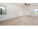 Spacious carpeted bedroom with two large windows and a ceiling fan at 1401 Brewer Jackson Ct, Wake Forest, NC 27587