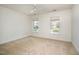 Carpeted bedroom with a ceiling fan and two large windows bringing in natural light at 1401 Brewer Jackson Ct, Wake Forest, NC 27587
