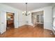Elegant dining room with hardwood floors, chandelier, and views of the kitchen at 1401 Brewer Jackson Ct, Wake Forest, NC 27587