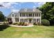 Classic brick home with black shutters, lush landscaping, and a well-maintained lawn at 1401 Brewer Jackson Ct, Wake Forest, NC 27587