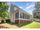 Exterior view of a home with a screened porch and well-maintained yard at 1401 Brewer Jackson Ct, Wake Forest, NC 27587