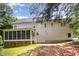 Back exterior of house with screened porch and manicured lawn under blue sky at 1401 Brewer Jackson Ct, Wake Forest, NC 27587