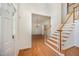 Spacious foyer with hardwood floors, a staircase, and view into the dining room at 1401 Brewer Jackson Ct, Wake Forest, NC 27587