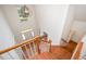 Bright foyer with hardwood stairs, white trim, and a modern chandelier at 1401 Brewer Jackson Ct, Wake Forest, NC 27587
