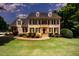 Lovely two-story brick home with black shutters, dormer windows and manicured landscaping at 1401 Brewer Jackson Ct, Wake Forest, NC 27587