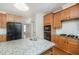 Kitchen with granite countertops, subway tile backsplash, stainless steel appliances, and wood cabinets at 1401 Brewer Jackson Ct, Wake Forest, NC 27587