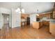 Open-concept kitchen and dining area with hardwood floors, granite counters, and stainless appliances at 1401 Brewer Jackson Ct, Wake Forest, NC 27587