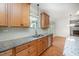 Kitchen details: Granite counters, stainless steel dishwasher, double sink, hardwood floors and wood cabinets at 1401 Brewer Jackson Ct, Wake Forest, NC 27587