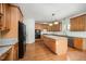 Spacious kitchen with wood cabinets, granite countertops, stainless steel appliances, and an island at 1401 Brewer Jackson Ct, Wake Forest, NC 27587