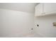 Laundry room with tile flooring, storage cabinets, and utility connections at 1401 Brewer Jackson Ct, Wake Forest, NC 27587
