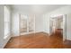 Bright living room with hardwood floors, white trim, French doors, and ample natural light at 1401 Brewer Jackson Ct, Wake Forest, NC 27587