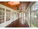 Inviting screened-in porch with wood floors, ceiling, and ample natural light at 1401 Brewer Jackson Ct, Wake Forest, NC 27587
