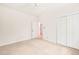 A bright bedroom featuring neutral walls, carpet and ample closet space at 1514 Lawrence Rd, Creedmoor, NC 27522
