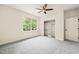Bright bedroom featuring gray carpet, ceiling fan, and natural light from the window at 1514 Lawrence Rd, Creedmoor, NC 27522