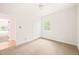 A cozy carpeted bedroom with a ceiling fan and natural light from the window at 1514 Lawrence Rd, Creedmoor, NC 27522
