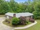 Aerial of a brick home with lush landscaping and a curved driveway at 1514 Lawrence Rd, Creedmoor, NC 27522