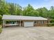 Brick house with a driveway and a covered parking area for the pool at 1514 Lawrence Rd, Creedmoor, NC 27522