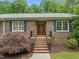 Charming brick home featuring an inviting front porch and decorative accents at 1514 Lawrence Rd, Creedmoor, NC 27522
