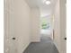 Hallway featuring carpeted floors that leads to an indoor pool area at 1514 Lawrence Rd, Creedmoor, NC 27522