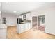 Bright kitchen features white cabinets, modern appliances, and sliding door access to the outdoor patio at 1514 Lawrence Rd, Creedmoor, NC 27522