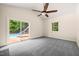 Bright living room with access to outdoor pool, featuring carpeted floors and ceiling fan at 1514 Lawrence Rd, Creedmoor, NC 27522