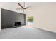 Cozy living room with a fireplace, ceiling fan, and sliding doors that open to the outdoor pool area at 1514 Lawrence Rd, Creedmoor, NC 27522
