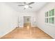 Bright living room with hardwood floors, ceiling fan, and double doors leading to another living space at 1514 Lawrence Rd, Creedmoor, NC 27522