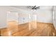 Open-concept living room with hardwood floors, white walls, and multiple doorways, providing a versatile layout at 1514 Lawrence Rd, Creedmoor, NC 27522