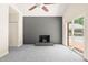Bright living room featuring a fireplace, ceiling fan, and sliding doors that open to the pool area at 1514 Lawrence Rd, Creedmoor, NC 27522