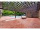 Outdoor pool area with tanning chairs and covered pergola at 1514 Lawrence Rd, Creedmoor, NC 27522