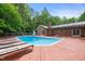 Inviting pool with slide and lounge chairs surrounded by mature trees at 1514 Lawrence Rd, Creedmoor, NC 27522