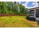 Spacious backyard with a manicured lawn and a grill at 152 Chauncey Cir, Chapel Hill, NC 27516