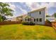 Expansive backyard featuring a well-manicured lawn, a cozy screened porch, and privacy fencing at 152 Chauncey Cir, Chapel Hill, NC 27516