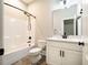 Bright bathroom features white cabinets, quartz countertop, framed mirror and bath tub with shower at 152 Chauncey Cir, Chapel Hill, NC 27516