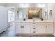 Bathroom featuring double sink vanity, large mirror, and walk-in shower at 152 Chauncey Cir, Chapel Hill, NC 27516