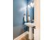 Powder room featuring a blue accent wall and pedestal sink at 152 Chauncey Cir, Chapel Hill, NC 27516