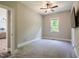 Bedroom with neutral carpet and paint, ceiling fan, and view to the backyard at 152 Chauncey Cir, Chapel Hill, NC 27516