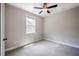 Spacious bedroom with a window, neutral color palette, and soft, gray carpeting at 152 Chauncey Cir, Chapel Hill, NC 27516