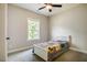 Cozy bedroom with a ceiling fan and window that offers a view of the green outdoor scenery at 152 Chauncey Cir, Chapel Hill, NC 27516