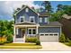 Charming two-story home boasts a welcoming front porch and attached two-car garage at 152 Chauncey Cir, Chapel Hill, NC 27516