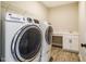 Well-equipped laundry room with modern washer and dryer units and a built-in sink at 152 Chauncey Cir, Chapel Hill, NC 27516