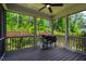 Relaxing screened-in porch featuring a grill and view of the wooded backyard at 152 Chauncey Cir, Chapel Hill, NC 27516