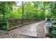 Scenic wooded walking trail with a bridge at 152 Chauncey Cir, Chapel Hill, NC 27516