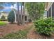 Landscaped backyard of a house with trees and shrubs at 1608 Heritage Links Dr, Wake Forest, NC 27587