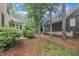 View of the backyard showing the manicured landscaping around the house and many trees at 1608 Heritage Links Dr, Wake Forest, NC 27587